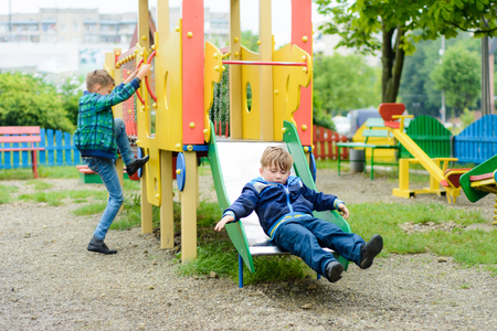 Funny children play on a childrens playgroundの写真素材