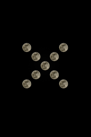 Moon isolated on black background. On a day of lunar eclipse in Ukraine over the mountains Carpathians, the moon looks very big and wonderfulの写真素材