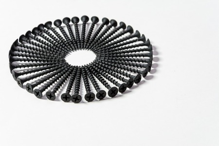 Photoset patterns arranged from black screws isolated on a white background in the form of a circle and a heartの写真素材