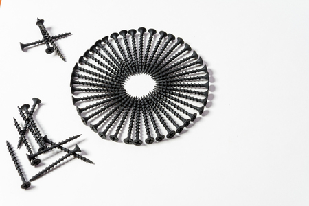 Photoset patterns arranged from black screws isolated on a white background in the form of a circle and a heartの写真素材