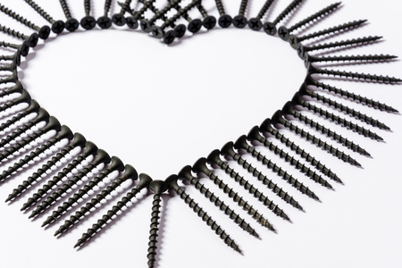Photoset patterns arranged from black screws isolated on a white background in the form of a circle and a heartの写真素材