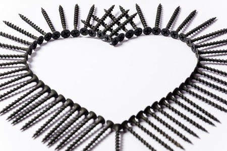 Photoset patterns arranged from black screws isolated on a white background in the form of a circle and a heartの写真素材