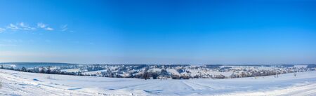 Amazing Ukrainian village with a charming sky in the snowy mountains, taken in the winterの写真素材