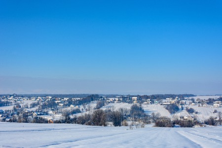 Amazing Ukrainian village with a charming sky in the snowy mountains, taken in the winterの写真素材