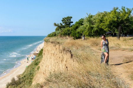 Photos of a wonderful woman in a beautiful dress that is resting on a Ukrainian beach in the Black Seaの写真素材