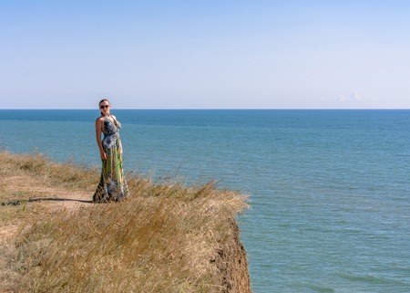 Photos of a wonderful woman in a beautiful dress that is resting on a Ukrainian beach in the Black Seaの写真素材