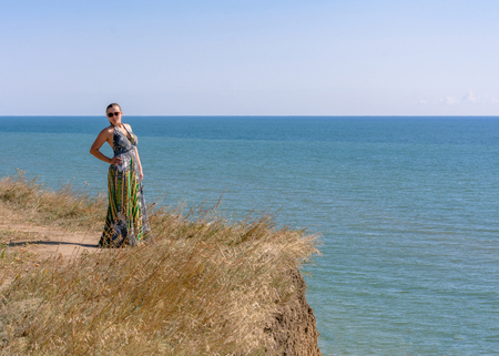 Photos of a wonderful woman in a beautiful dress that is resting on a Ukrainian beach in the Black Seaの写真素材