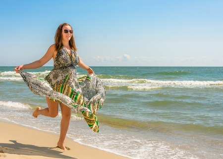 Photos of a wonderful woman in a beautiful dress that is resting on a Ukrainian beach in the Black Seaの写真素材
