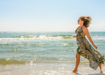 Photos of a wonderful woman in a beautiful dress that is resting on a Ukrainian beach in the Black Seaの写真素材
