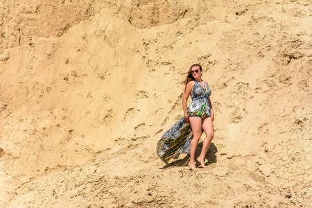 Photos of a wonderful woman in a beautiful dress that is resting on a Ukrainian beach in the Black Seaの写真素材