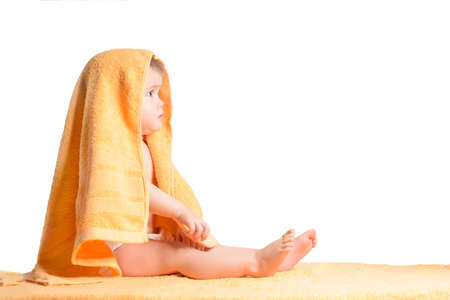 Little girl wrapped in yellow towel, isolated on white background 2018の写真素材
