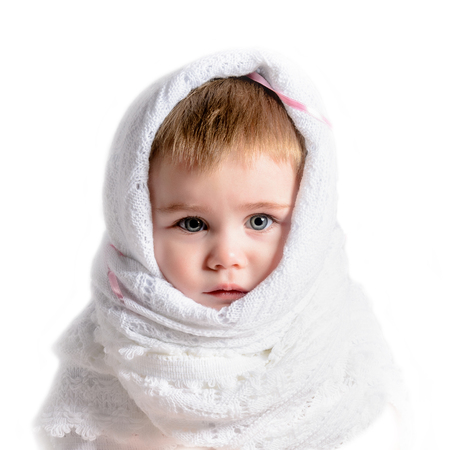 Sad small beautiful girl close-up in white scarf isolated on white background 2018の写真素材