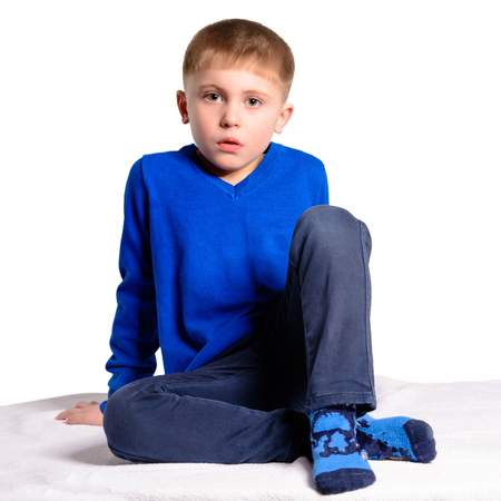 A boy in a blue jacket sits, isolated on a white background 2018の写真素材