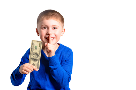 A little boy in a blue jacket holds a hundred dollars, isolated on a white backgroundの写真素材