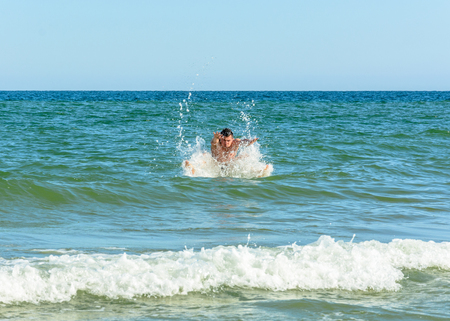 A sports man jumping over the sea waves in the black sea 2018の写真素材