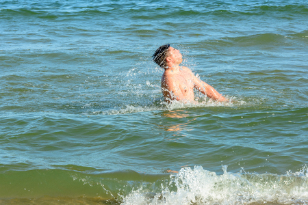 The man fluttered out of the sea and twirled his head 2018の写真素材