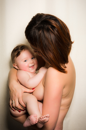 A young naked mother holds on her hands a wonderful nude baby 2018の写真素材