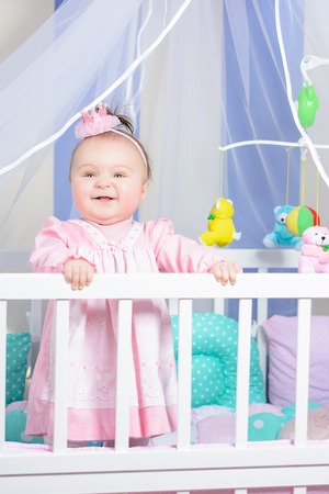 Beautiful portrait of a little girl in a pink dress in a nursery 2018の写真素材
