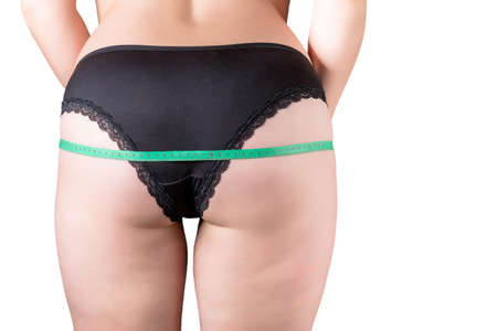 A girl plus size measures the volume of her hips in black undeearrw 2018の写真素材