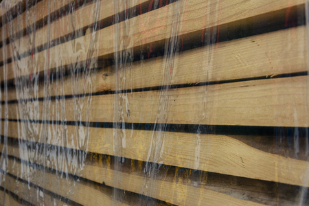 The wooden board is placed under a polyethylene filmの写真素材