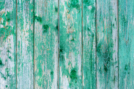 Amazingly beautiful old texture of a green wooden wall with cracked paintの写真素材