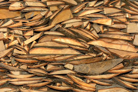 The texture of a wooden cut board with bark, which is chaoticly slipperyの写真素材