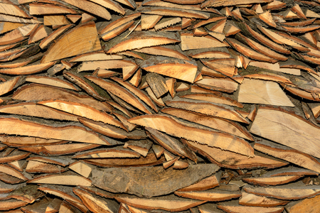 The texture of a wooden cut board with bark, which is chaoticly slipperyの写真素材