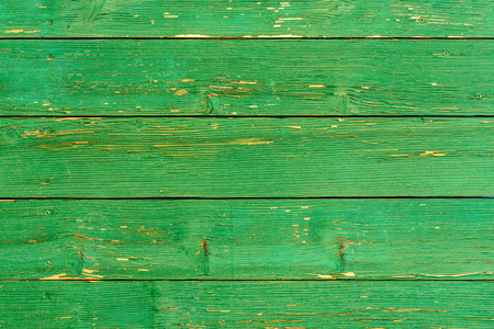 Amazingly beautiful old texture of a green wooden wall with cracked paintの写真素材