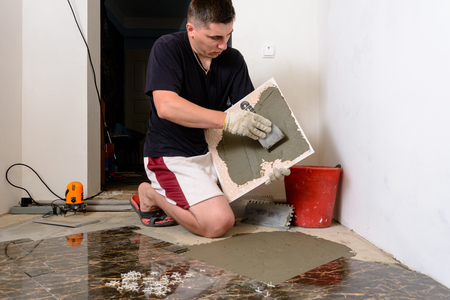 The master tile smears the mucilage solution on the marble tile 2018の写真素材