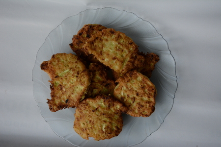 fried zucchini fritters on a wooden tablechopsticks from the fragrant green courgettes of the homemade cuisineの写真素材