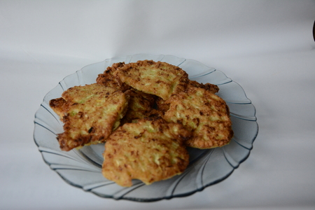fried zucchini fritters on a wooden tablechopsticks from the fragrant green courgettes of the homemade cuisineの写真素材