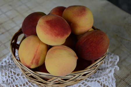 Fresh fragrant and sweet peaches in the basketの写真素材
