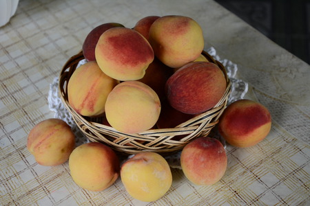 Fresh fragrant and sweet peaches in the basketの写真素材