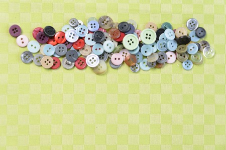 Colored small buttons on a green backgroundの写真素材
