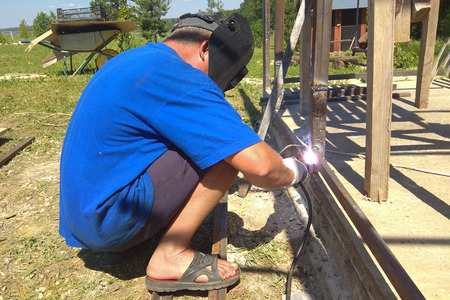A man weld metal on the streetの写真素材