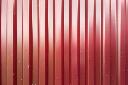 Red zinc metal sheet texture with stainless bolt, metal wall or roofの写真素材