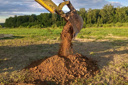 A work excavator digging a trench for the foundation of a buildingの写真素材