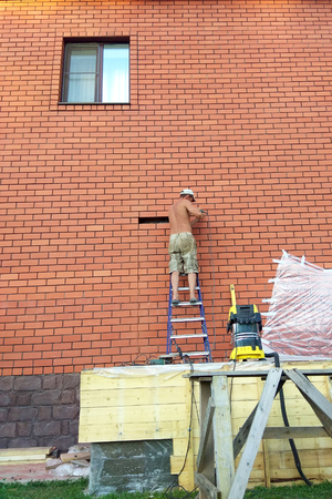 The builder performs work on the ladder 2018の写真素材