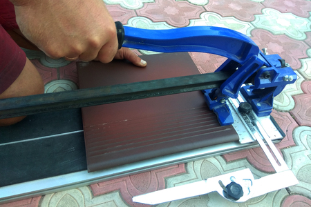 the worker cuts the ceramic tile on the manual tile 2018の写真素材