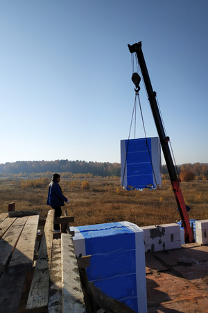 the employee controls the unloading of blocks for the construction of a house at the time farm 2018の写真素材