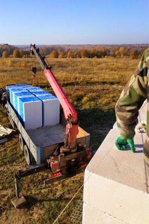 unloading of blocks by automobile crane on the construction site 2018の写真素材