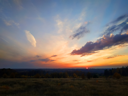 Unbeatable sky on the fall day during the sunset somewhere far away in the field 2018の写真素材