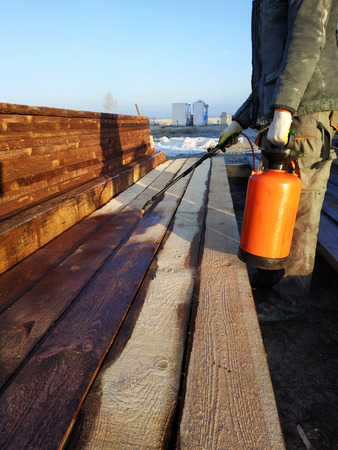 During the coloring of the boards, the worker uses a spray gun under pressure 2018の写真素材