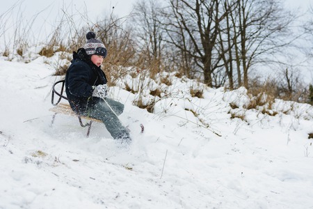 the child tries to stay in the sled so as not to fall