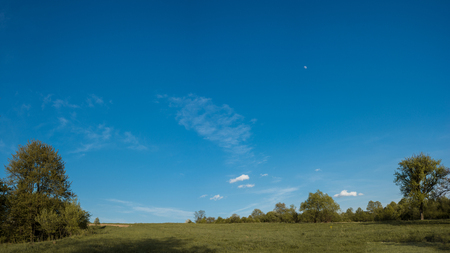 A beautiful moon on a daytime blue, magical sky with white clouds 2019の写真素材