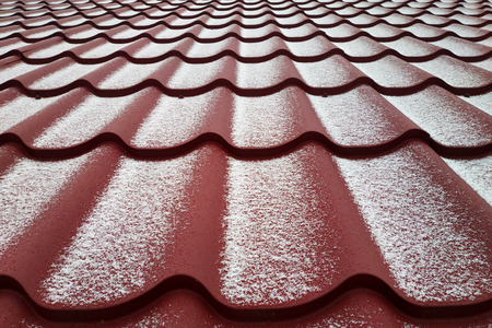 The white snow adorned the red metal, the texture.の写真素材