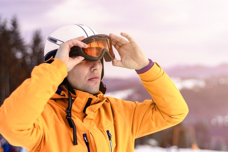 A man skier wearing a helmet and sunglasses before training for safetyの写真素材