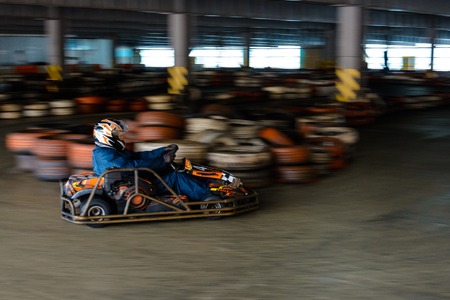Dynamic karting competition at speed with blurry motion on an equipped racecourseの写真素材