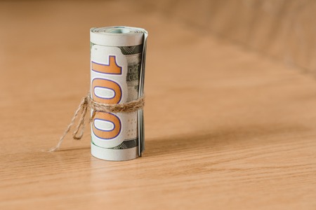 Stoldier's bills are rolled up with a fabric rope on a brown background. 2019の写真素材