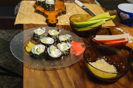 A plate with sushi roles in the kitchen, cooked by a woman's chef with her own hands 2019の写真素材